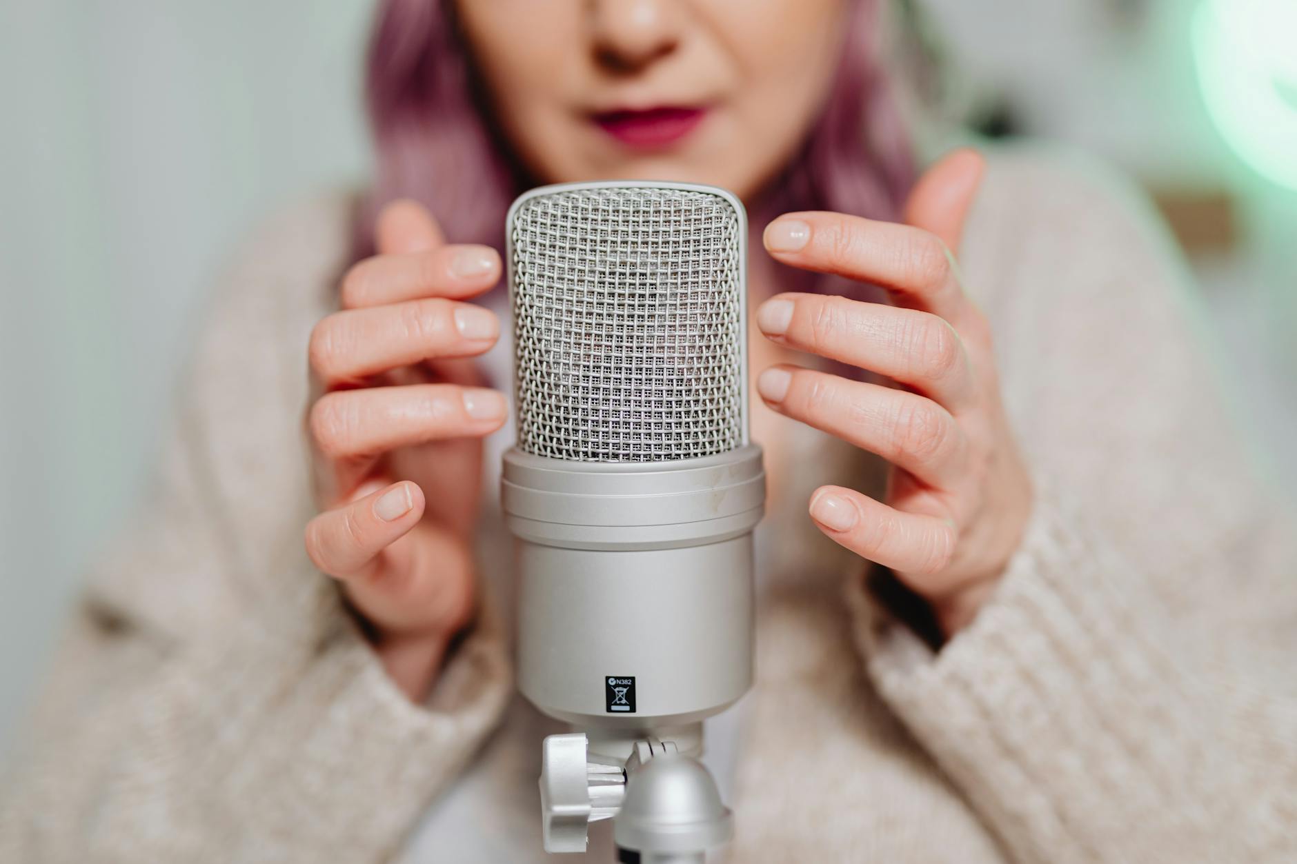 a woman touching a microphone