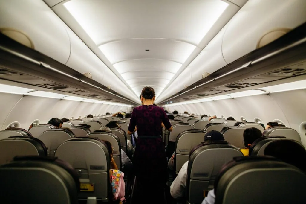 person standing inside airliner